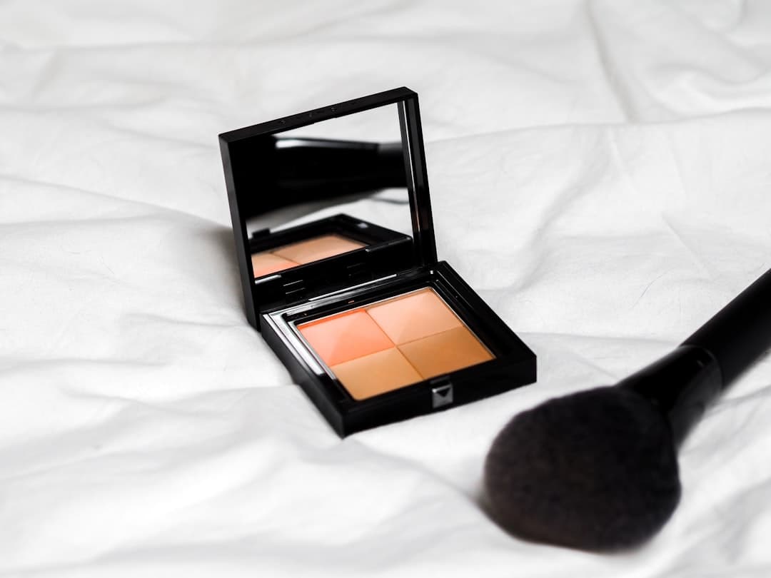 Contouring palette and brushes on beige textured surface